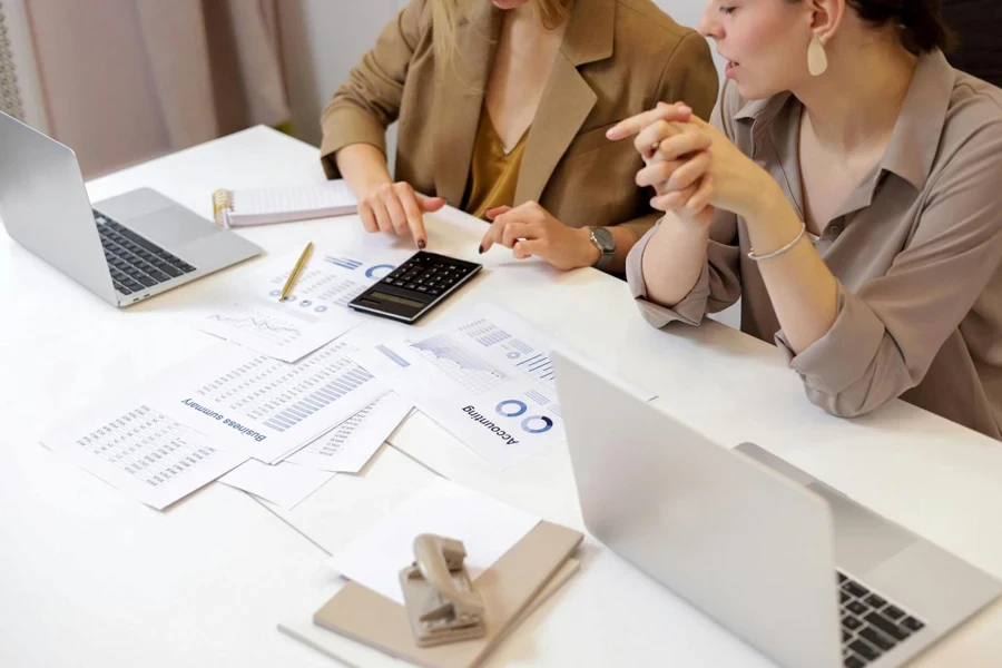 Women sitting at a table looking at papers