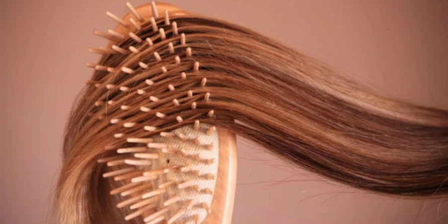 Young Woman with Comb Brushing Her Blonde Hai