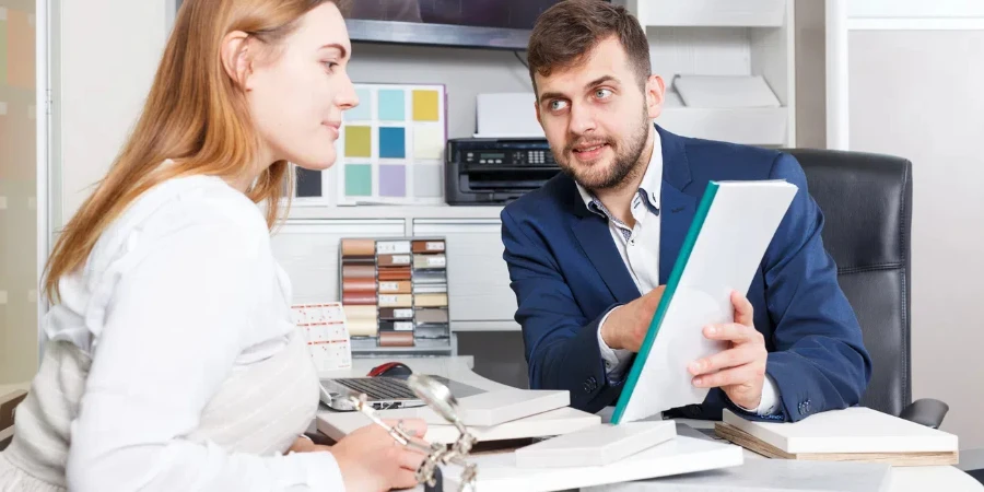 Young client woman discussing with salesman agreement on furniture purchase in showroom