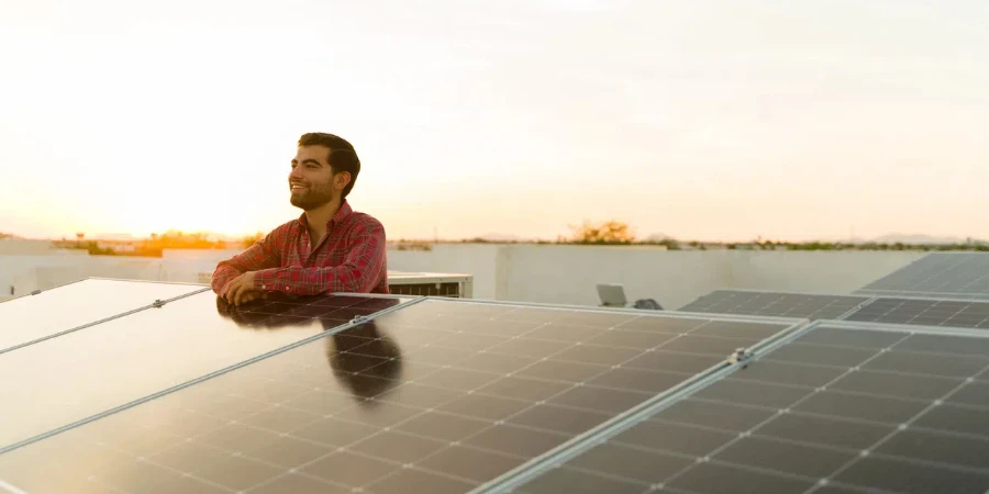 Young man at the rooftop using clean solar green energy