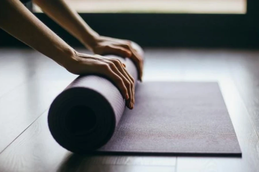 Young woman doing yoga twist mat