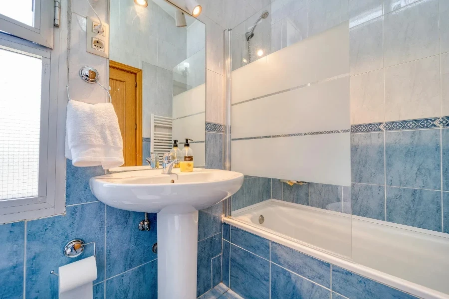 A bathroom with blue and white tiles