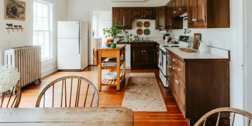 A brown themed kitchen with a kitchen runner rug