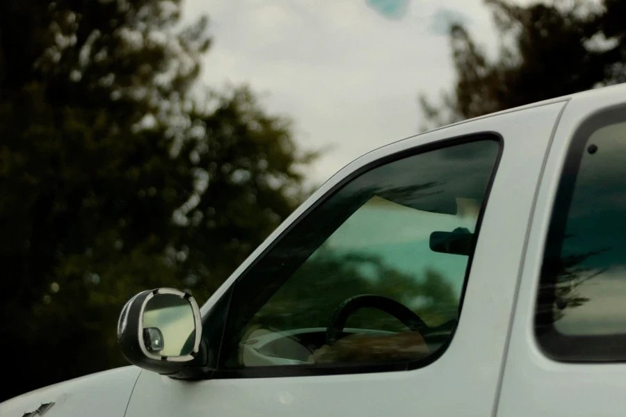 a close up of the side mirror of a white truck