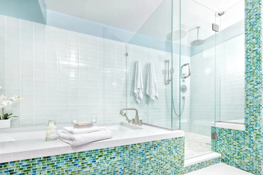 A contemporary bathroom with green and blue tiles