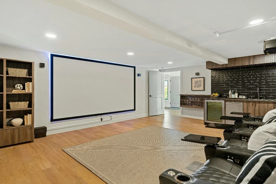 a living room with speakers and a large projection screen