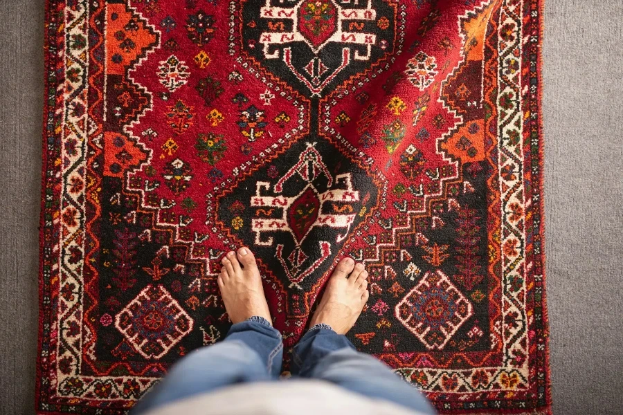 A person standing on a vintage rug