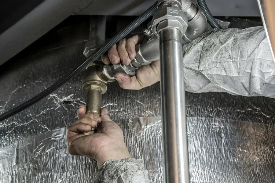 A plumber installing pipe fittings