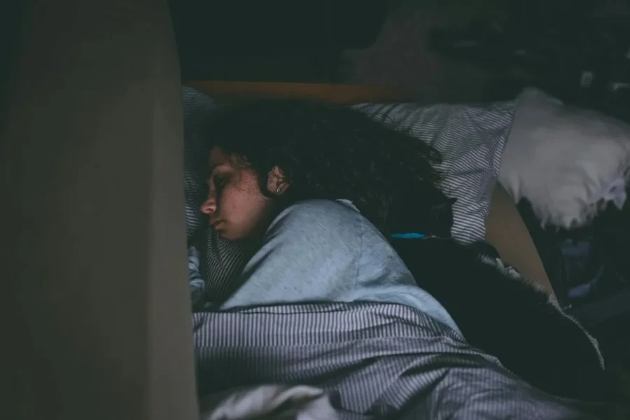 A woman sleeping in a bed