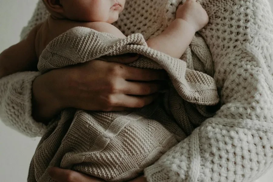 A woman snuggling a baby