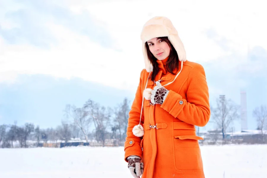 A woman wearing an orange duffle coat