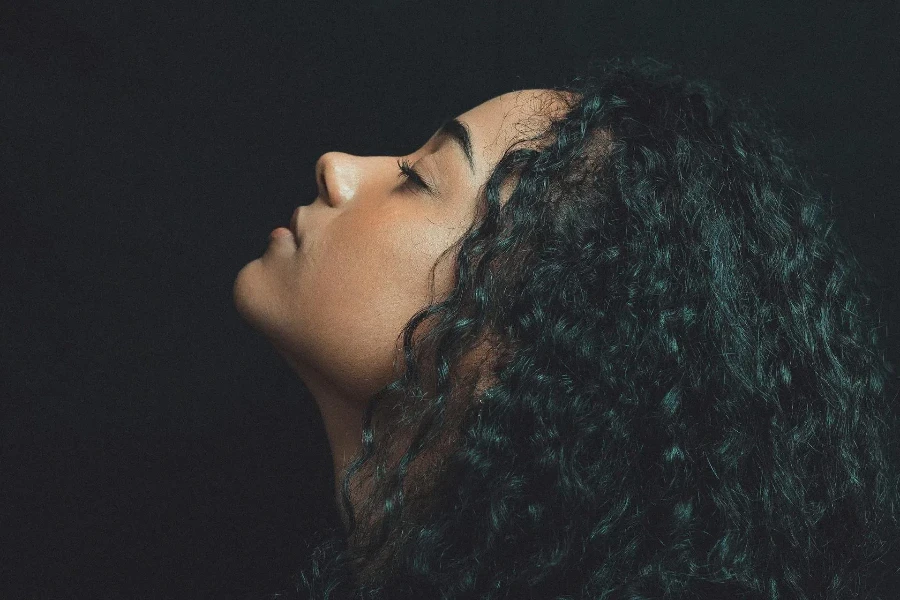 A woman with long, black curly hair