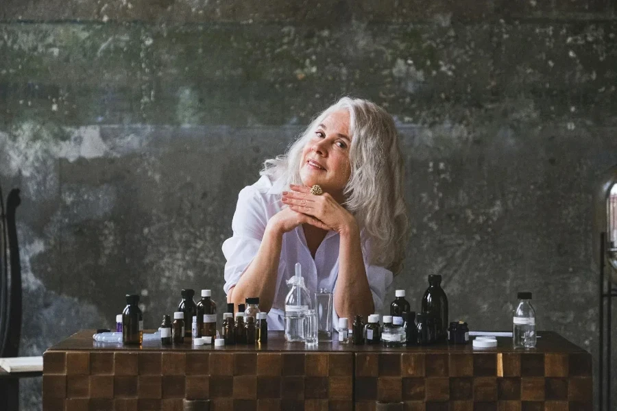 Elderly woman in front of amber bottles