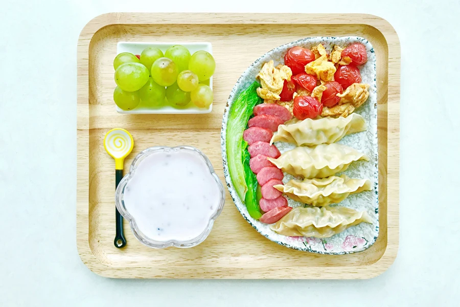 food on ceramic plates on square wooden tray