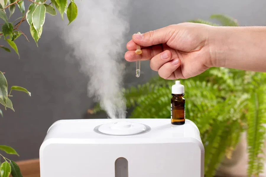 Man adding essential oil to diffuser