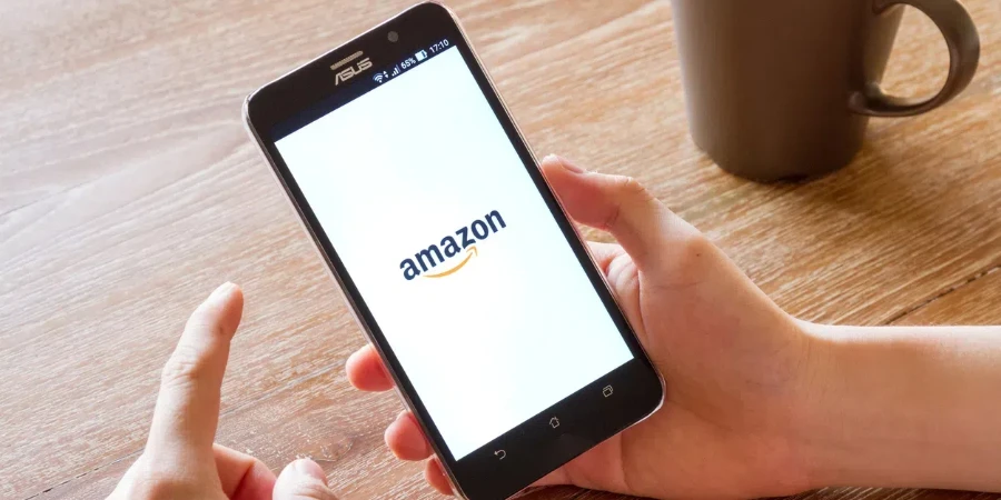 man hand holding screen shot of Amazon application