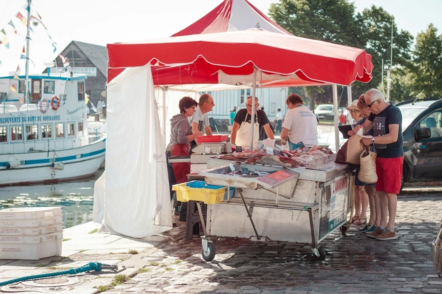 people sitting on white canopy tent during daytime