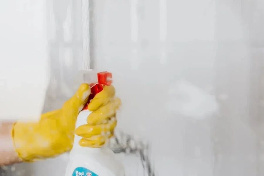 person cleaning a glass surface