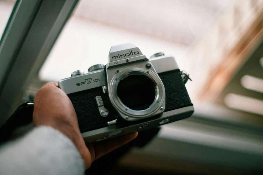 person holding gray and black camera