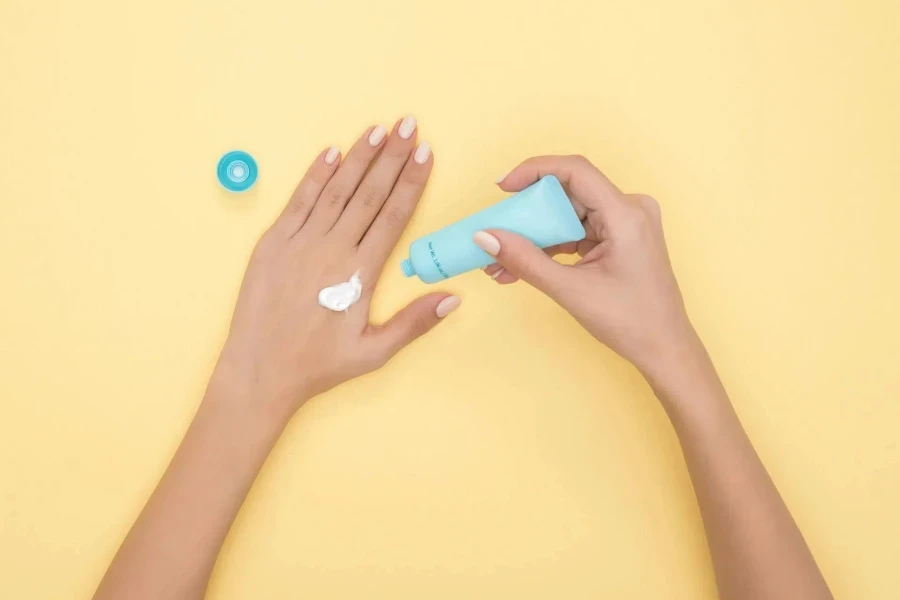 Person pouring sunscreen from a tube