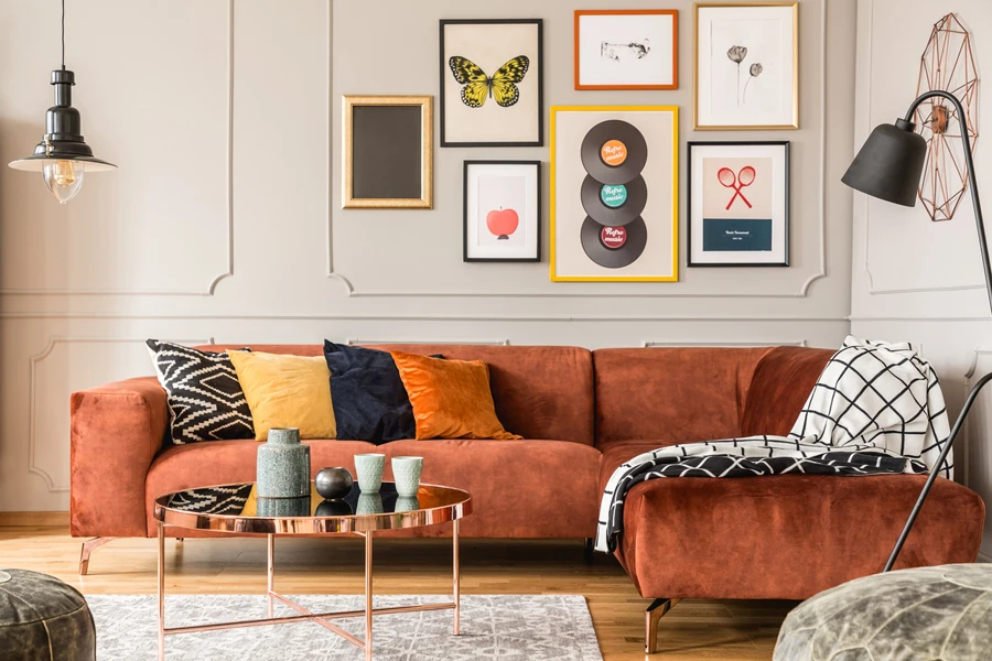 velvet sofa, coffee table and colorful throw pillows in eclectic living room design