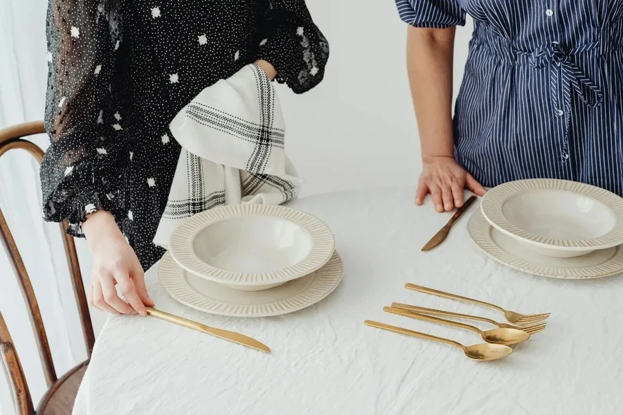 Woman cleaning plates with a small towel