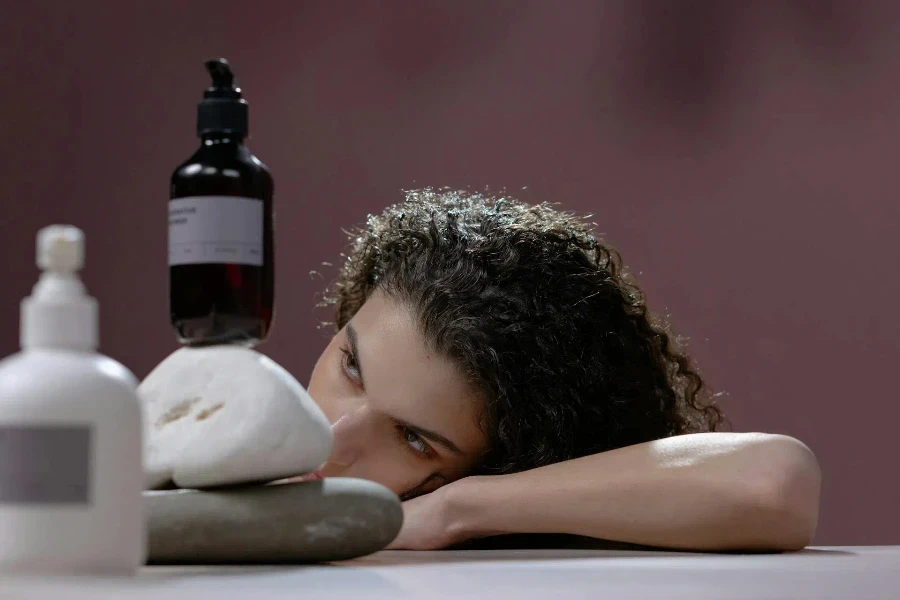 Woman staring at a bottle of shampoo