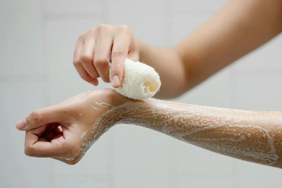 Woman washing arms with soap