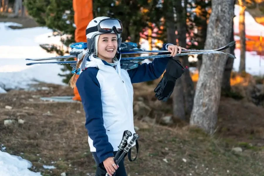 A smiling young girl wearing a ski jacket