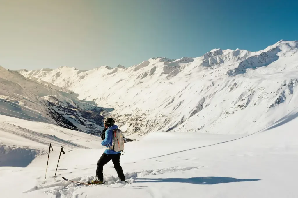 man holding his bear on snow field during daytime