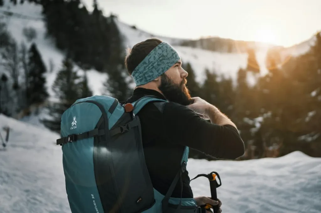 man holding his bear on snow field during daytime