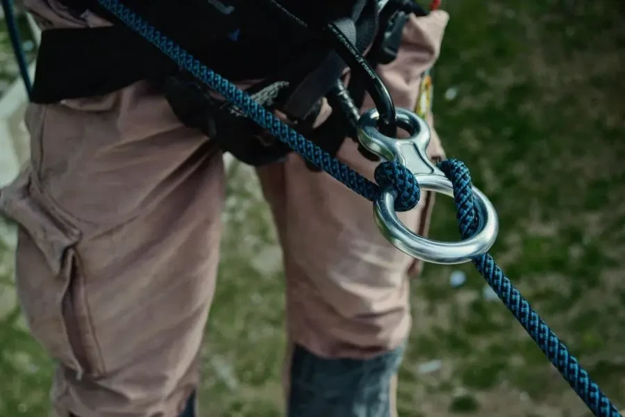 Detailed view of climbing gear showing carabiners and ropes on an outdoor adventure