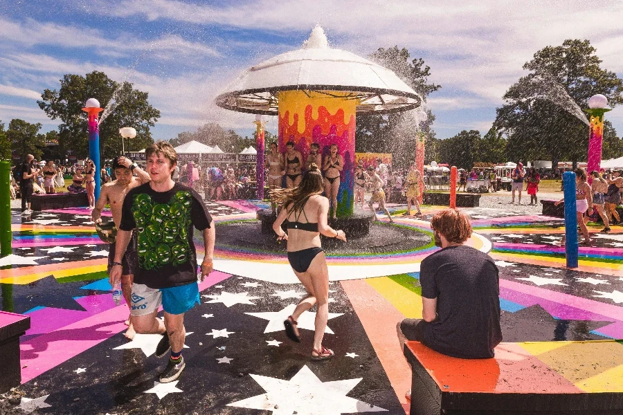 People enjoying colorful water park on a sunny summer day, full of fun and laughter