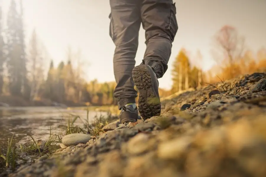 men's footsteps on the beach of river