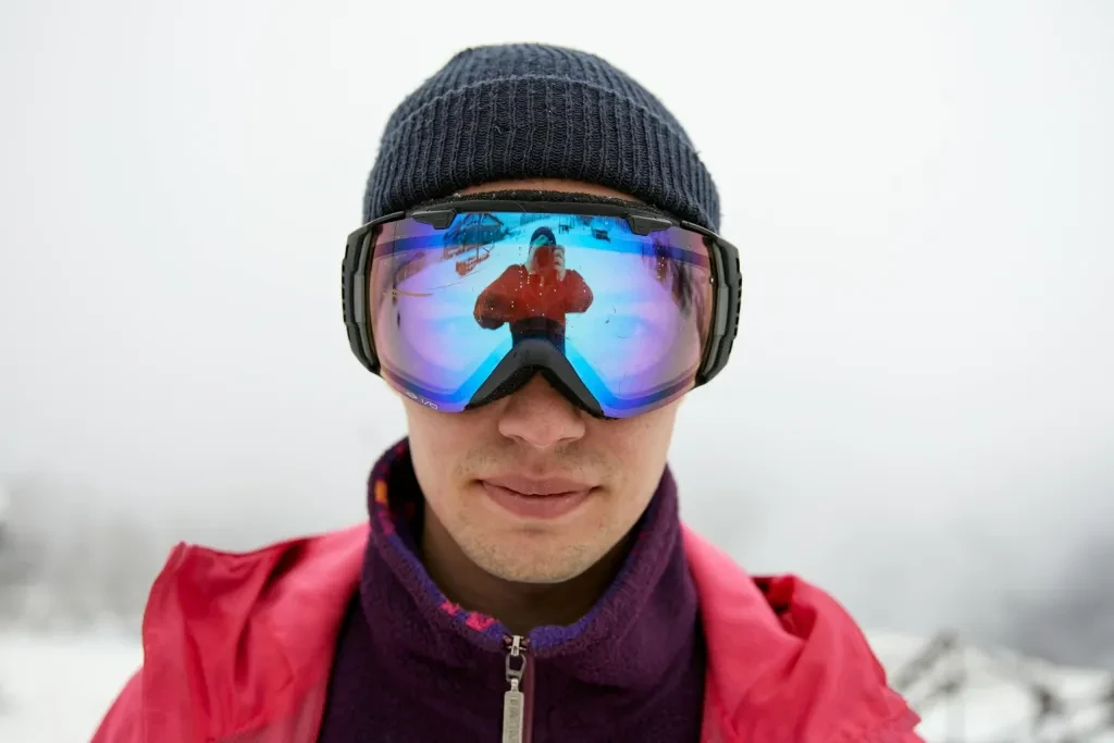 Close-up of a man in winter 5_clothing with reflective snow goggles showing a reflection by Darina Belonogova