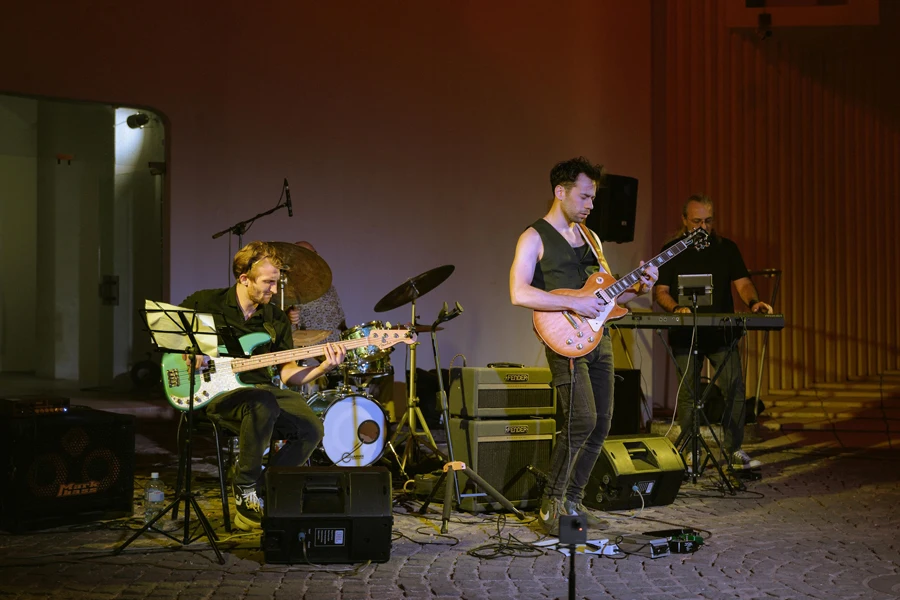 A band playing music in a room with a stage