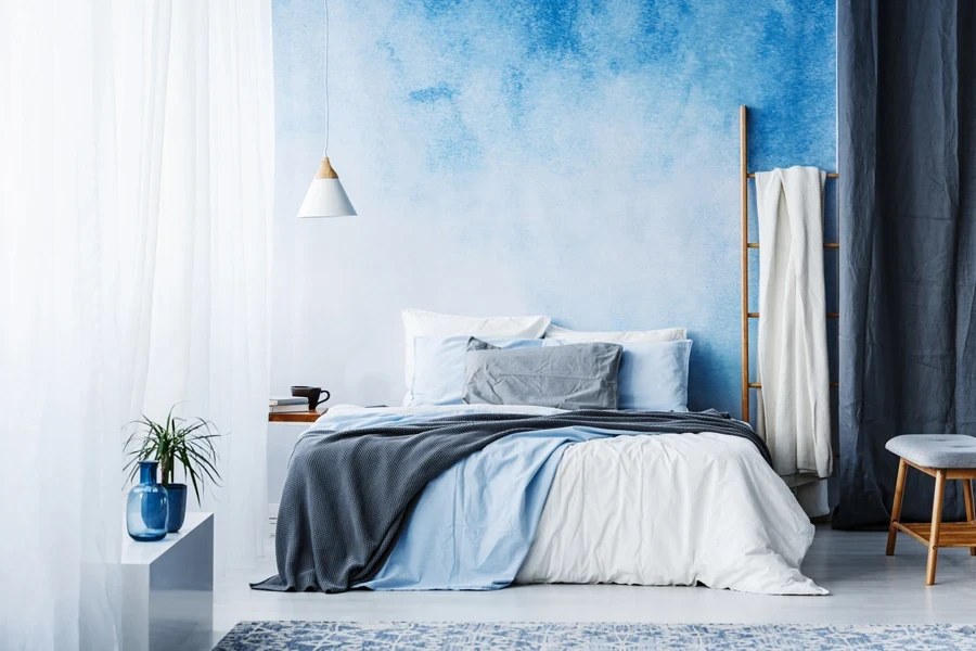 A bedroom with blue and white ombre paint