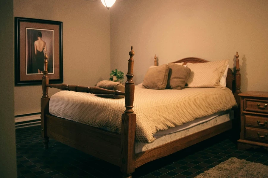 A cozy bed and a poster on wall in a room