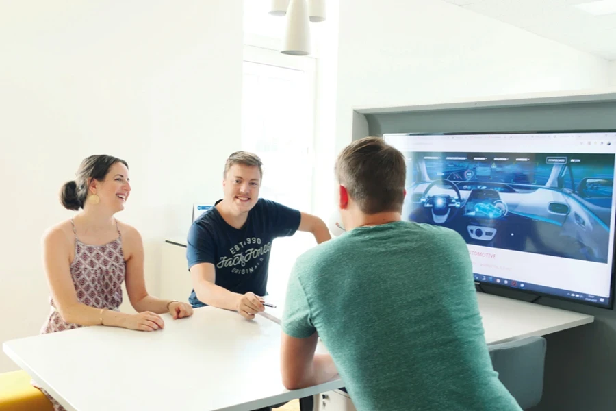 A group of people sitting around a table and TV