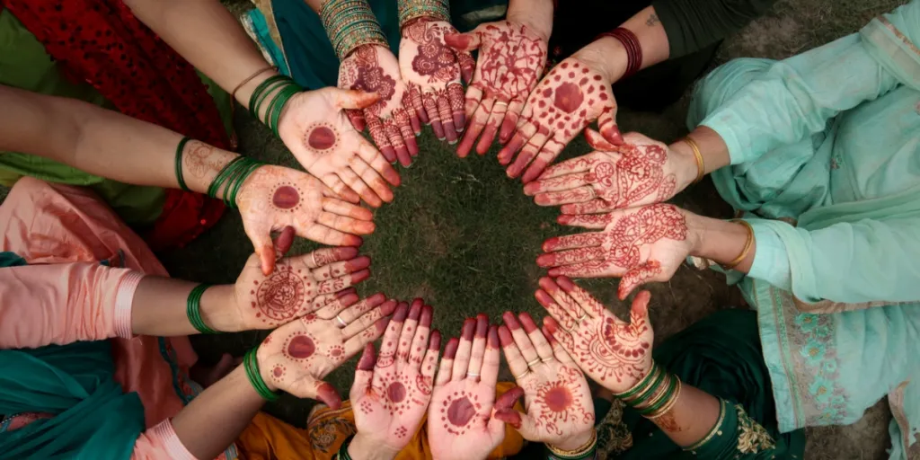 A group of women showing henna hands