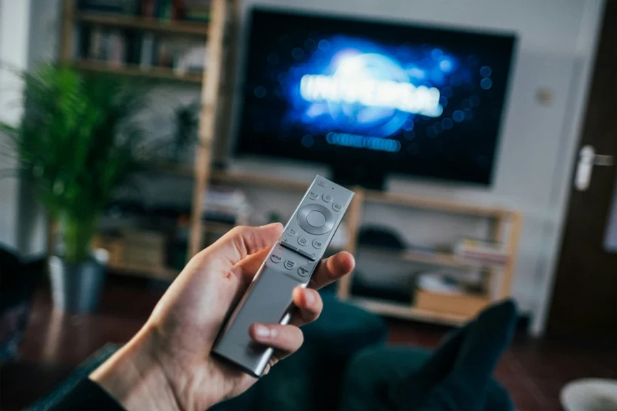 A hand holding a remote control