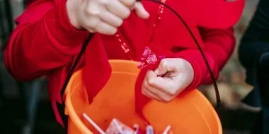 A person holding a string in a bucket