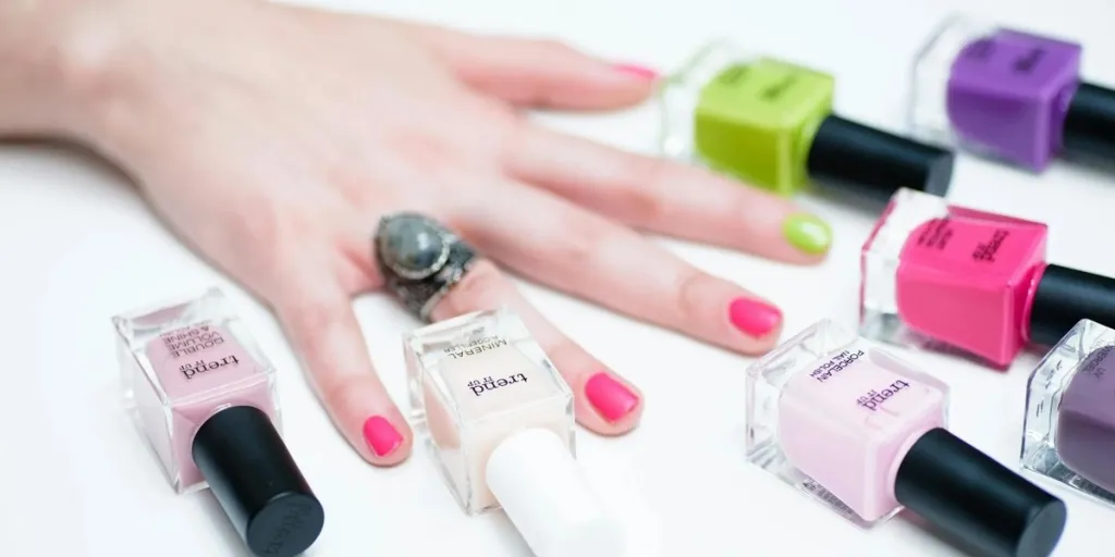 A person’s hands with colorful nail colors