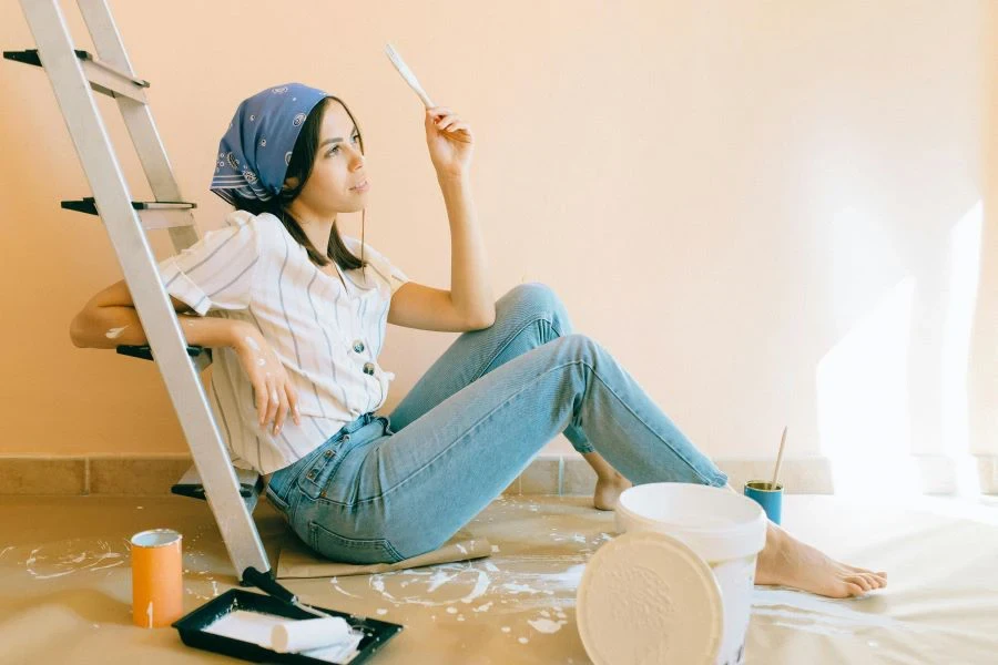 A woman holding a paintbrush