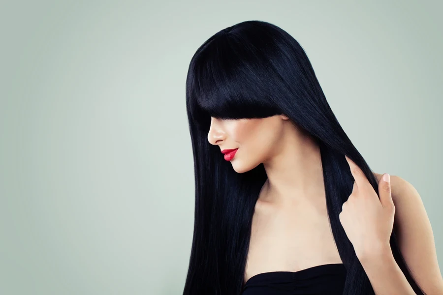 A woman wearing a long black straight wig