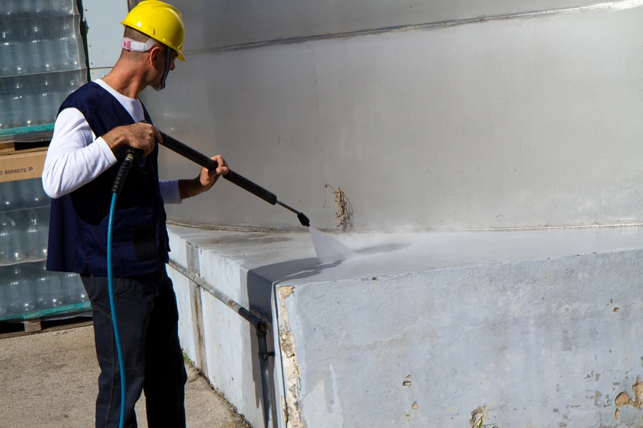 A worker using a dry ice blaster