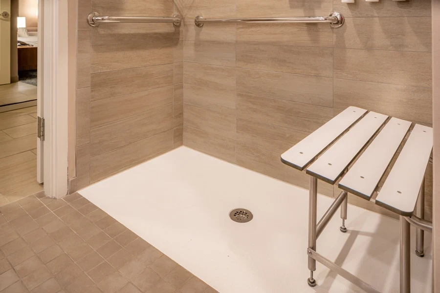 Accessible shower with adjustable bench