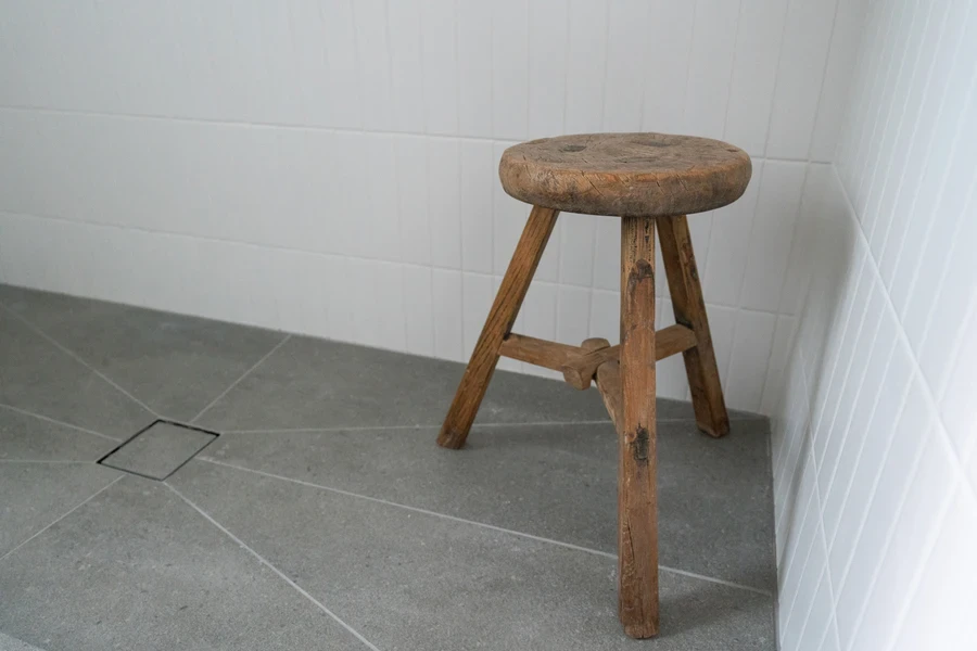 Bathroom shower with wooden corner shower stool