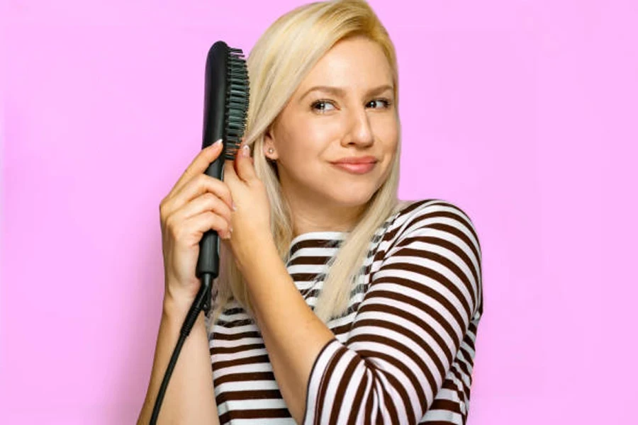 Beautiful Blonde Natural Woman Using Electric Comb