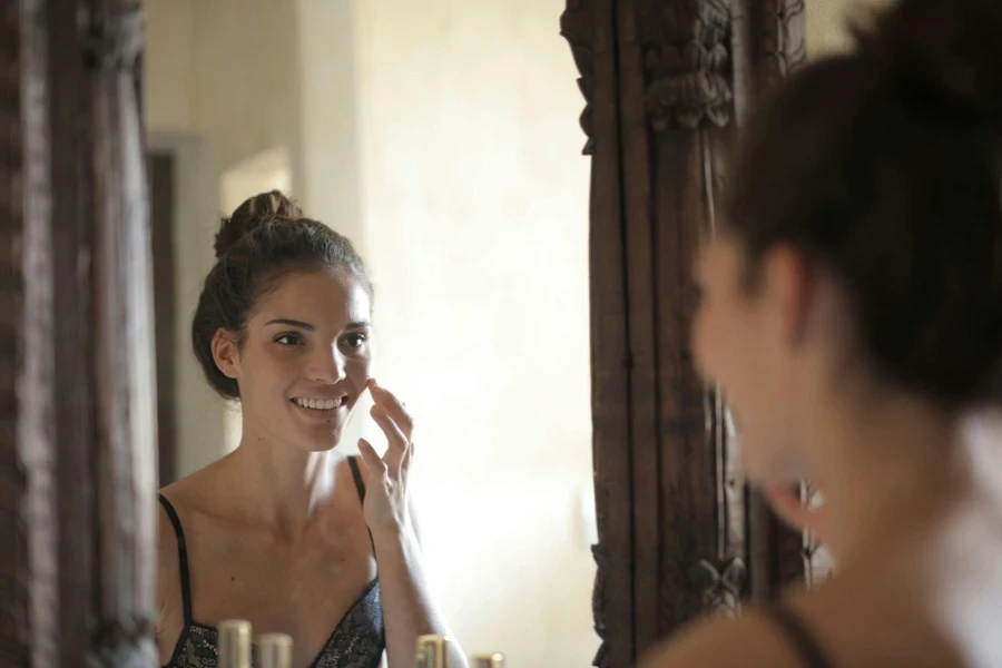 Beautiful Woman Doing Skincare in the Mirror